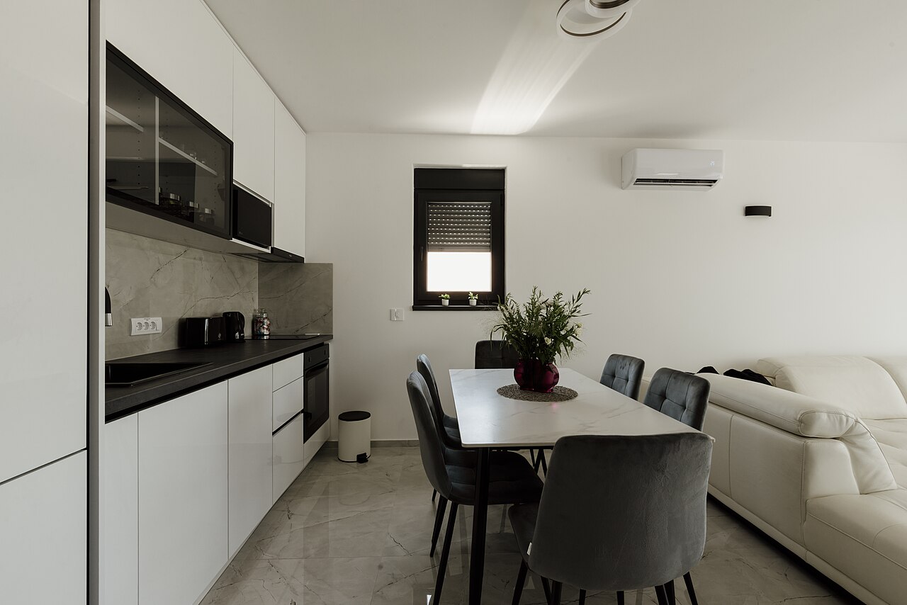 Clean modern kitchen and dining area with a set table