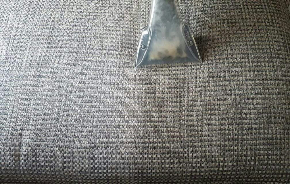 Upholstery extraction nozzle cleaning woven fabric close up